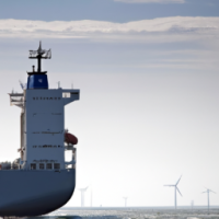 A container vessel powered by wind, having wind sails shaped like airplane wings