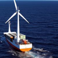 A container vessel powered by wind, having wind sails and sailing at sea